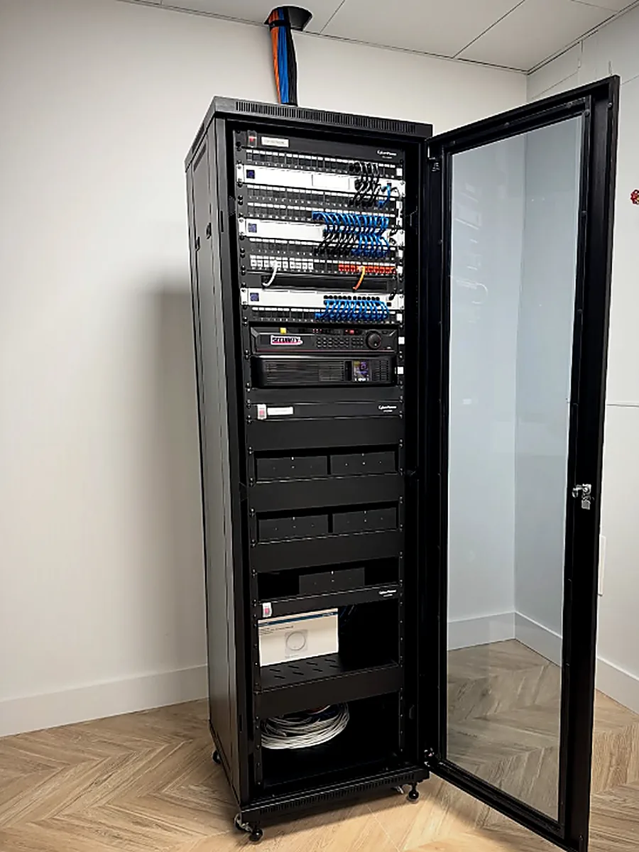 Full-height network rack with labeled patch panels installed by Lynx Technology