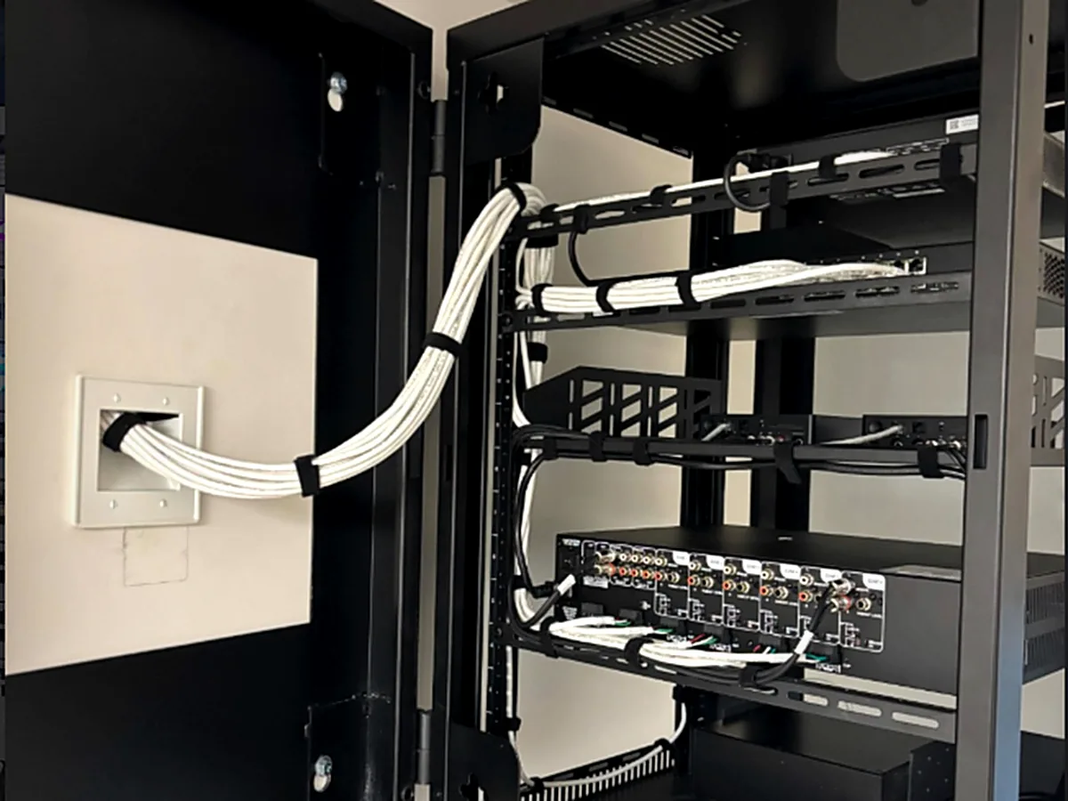 Structured wiring enclosure with a terminated patch panel and managed cable